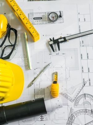 construction-plans-with-helmet-drawing-tools-blueprints_1232-4301
